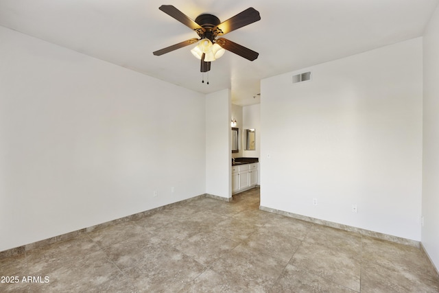 empty room featuring visible vents, baseboards, and a ceiling fan