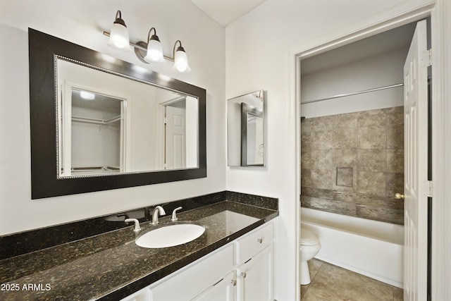 bathroom featuring toilet, tile patterned flooring, shower / tub combination, and vanity