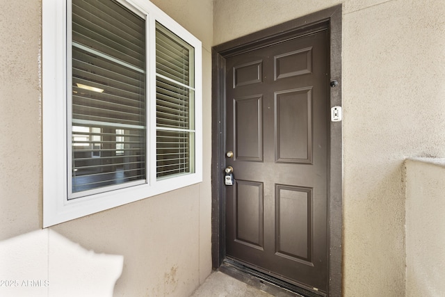 property entrance featuring stucco siding