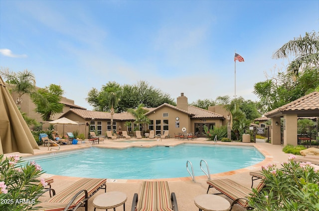 pool featuring a patio area and fence