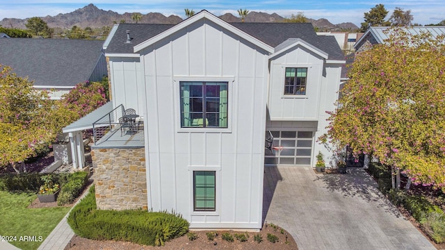 modern inspired farmhouse featuring a garage and a mountain view