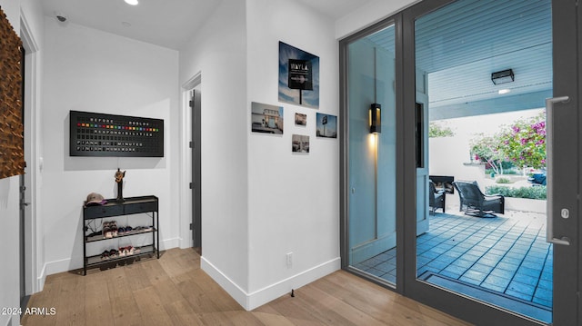 hallway with hardwood / wood-style flooring