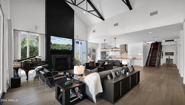 living room featuring hardwood / wood-style floors and high vaulted ceiling