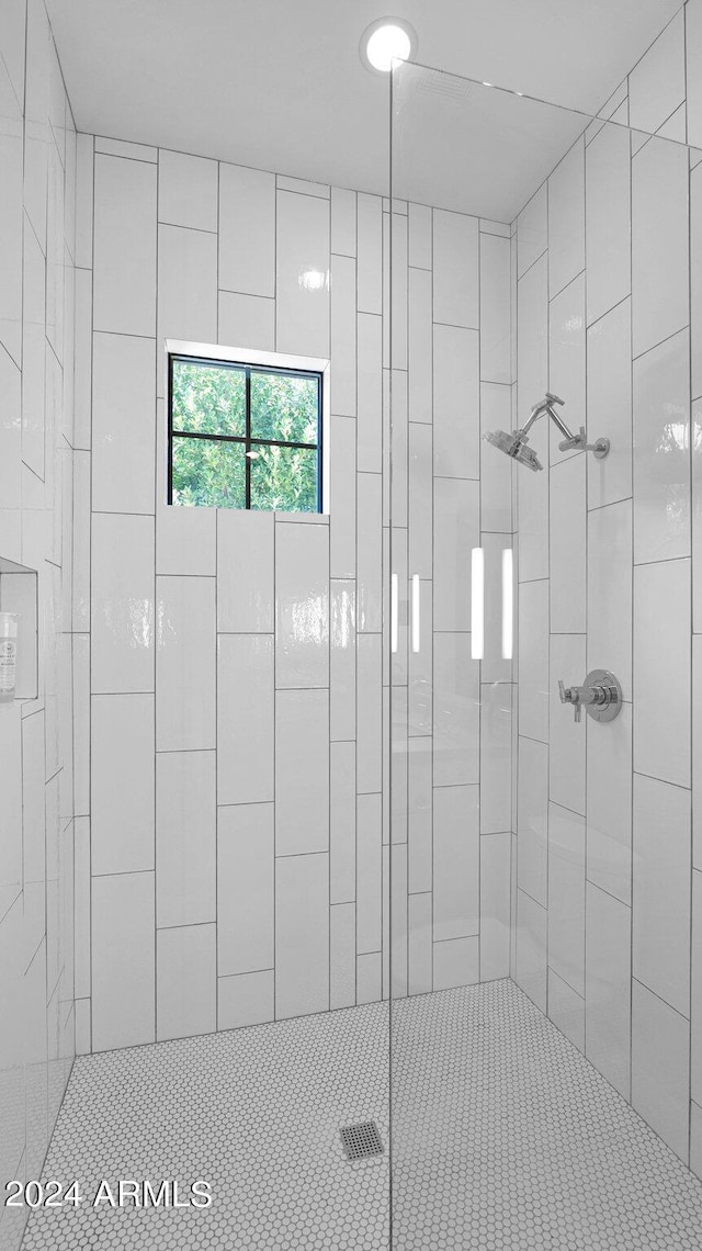 bathroom featuring a shower with shower door