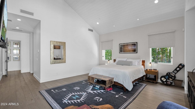 bedroom featuring high vaulted ceiling, wooden ceiling, and hardwood / wood-style floors