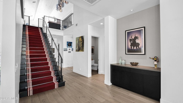 interior space with light hardwood / wood-style flooring and a high ceiling