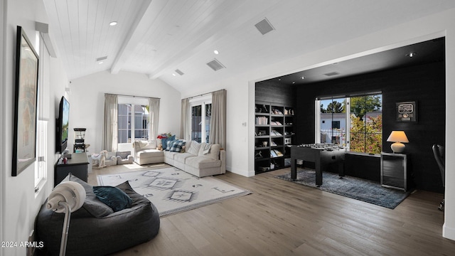 living room featuring vaulted ceiling with beams and wood-type flooring