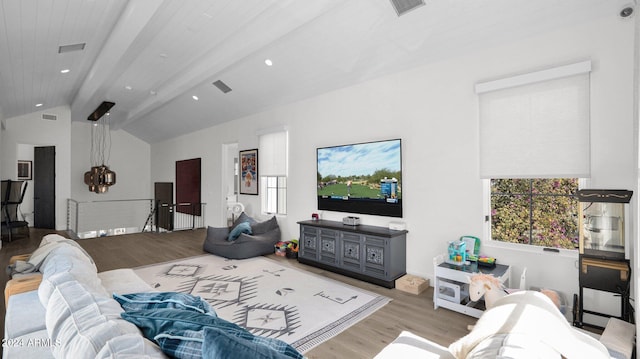 living room with lofted ceiling with beams and light wood-type flooring