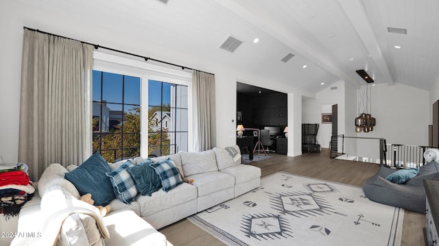 living room featuring lofted ceiling with beams and wood-type flooring