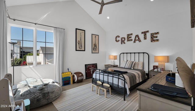 bedroom with ceiling fan, light hardwood / wood-style floors, and high vaulted ceiling