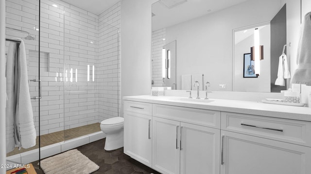 bathroom featuring vanity, toilet, and an enclosed shower