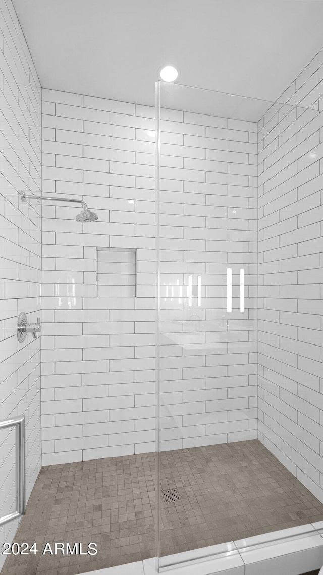 bathroom with a tile shower