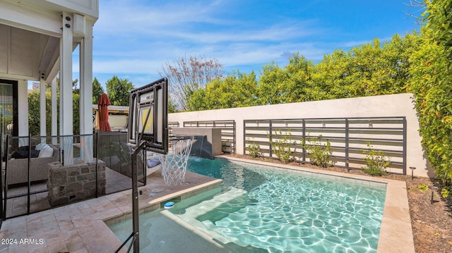 view of swimming pool with a patio and pool water feature