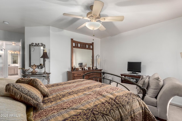 carpeted bedroom with ceiling fan and ensuite bath