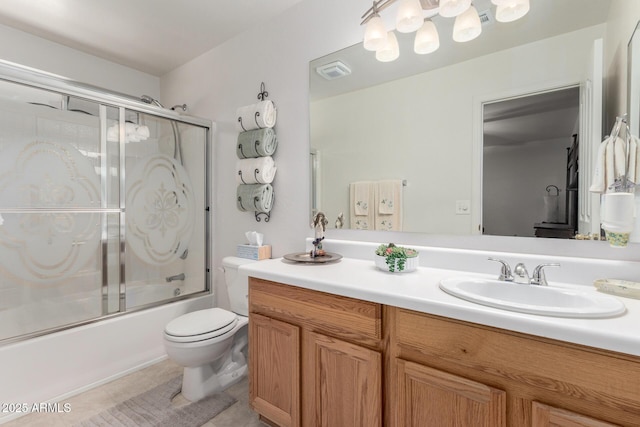 full bathroom with tile patterned flooring, enclosed tub / shower combo, vanity, and toilet