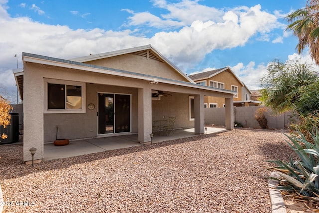 back of property with ceiling fan and a patio