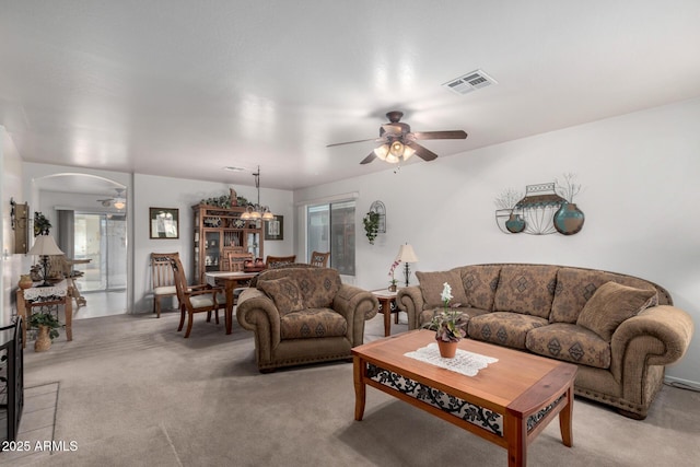 living room with light carpet and ceiling fan