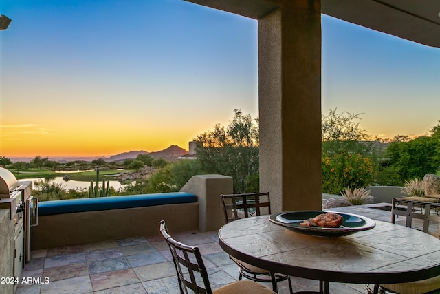 patio terrace at dusk with a water view