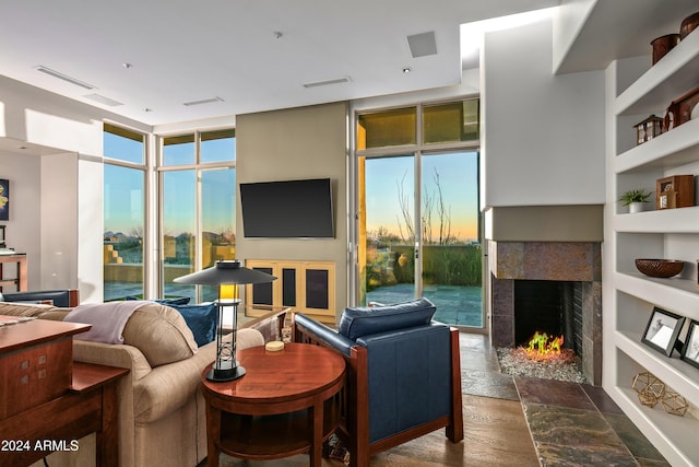 living room with built in shelves, expansive windows, and plenty of natural light