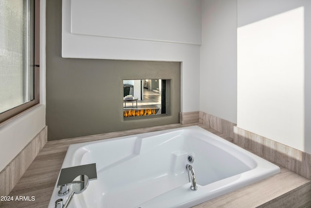 bathroom featuring a relaxing tiled tub