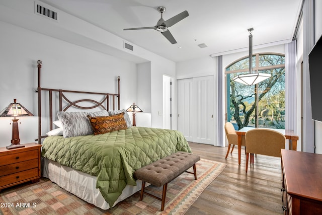 bedroom featuring ceiling fan, light wood-type flooring, and a closet