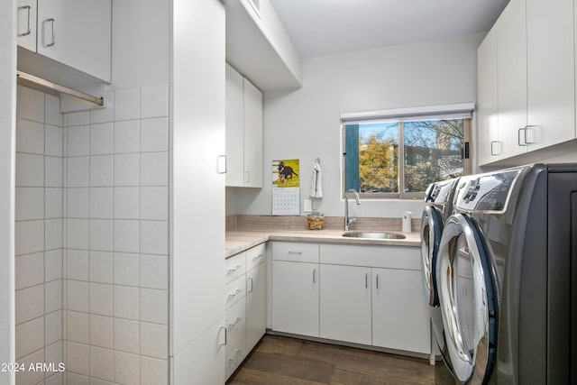 laundry area with separate washer and dryer, sink, cabinets, and dark hardwood / wood-style floors