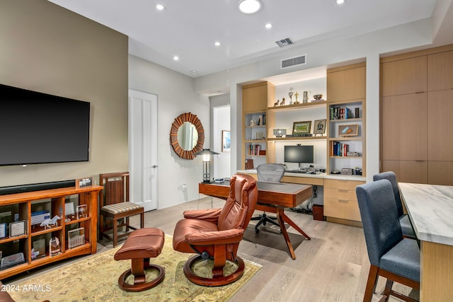 office area featuring light hardwood / wood-style flooring and built in desk