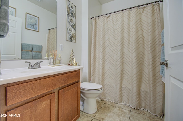 bathroom featuring toilet, vanity, tile patterned floors, and walk in shower