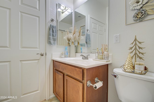 bathroom with vanity and toilet