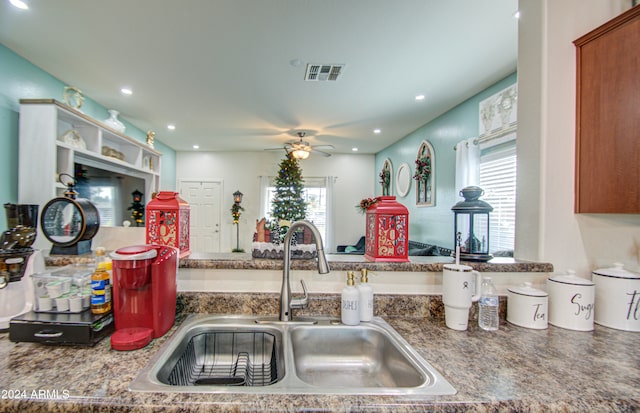 kitchen featuring ceiling fan and sink