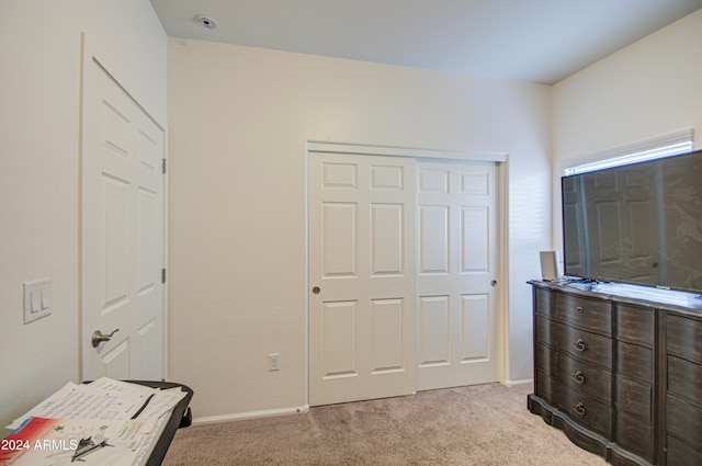 carpeted bedroom featuring a closet