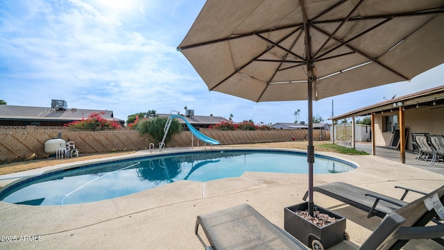 view of swimming pool featuring a patio area and a water slide