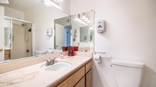 bathroom featuring vanity, toilet, and an enclosed shower