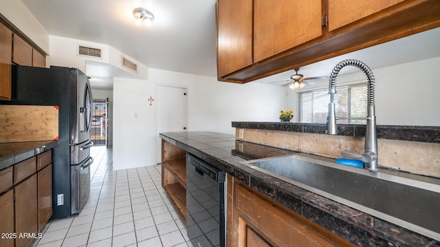 kitchen with light tile patterned flooring, ceiling fan, sink, and black appliances