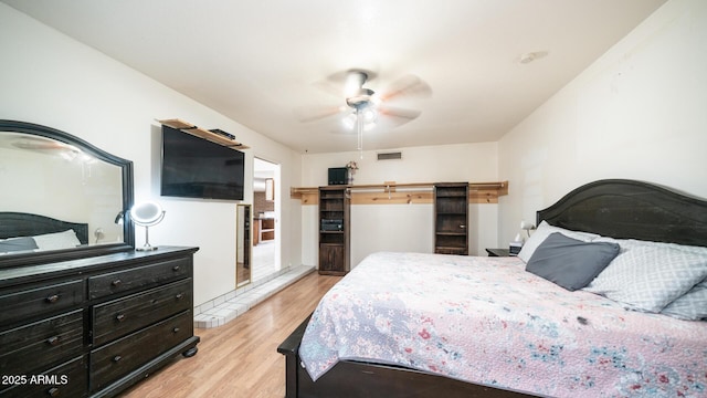 bedroom with light hardwood / wood-style flooring and ceiling fan