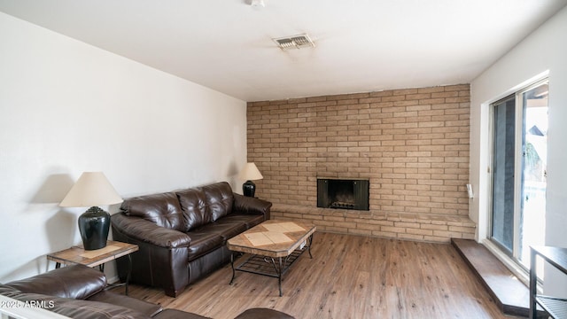 living room featuring a fireplace and hardwood / wood-style floors