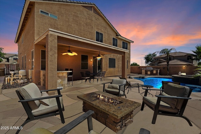 25818 N 68th Ave, Peoria, AZ 85383 - patio terrace at dusk with a fire pit, a patio area, a ceiling fan, and a fenced backyard