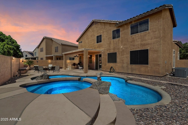 25818 N 68th Ave, Peoria, AZ 85383 - pool at dusk featuring a patio area, ceiling fan, an in-ground hot tub, and a fenced backyard