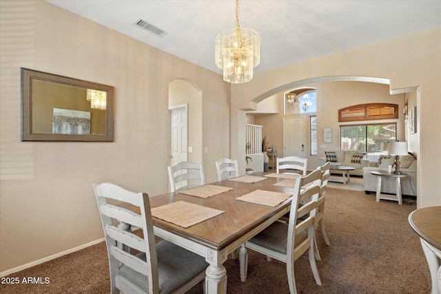 25818 N 68th Ave, Peoria, AZ 85383 - carpeted dining room featuring arched walkways and a chandelier