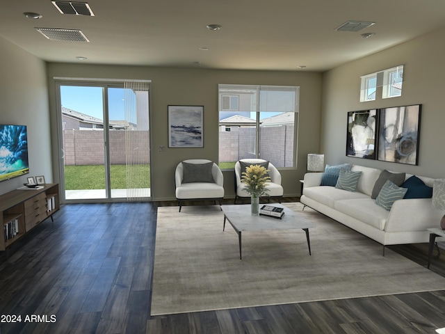 living room featuring a healthy amount of sunlight and dark hardwood / wood-style floors