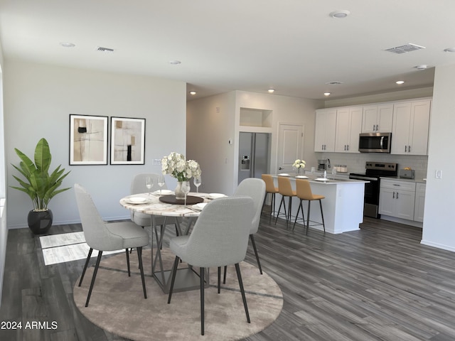 dining room with dark hardwood / wood-style flooring