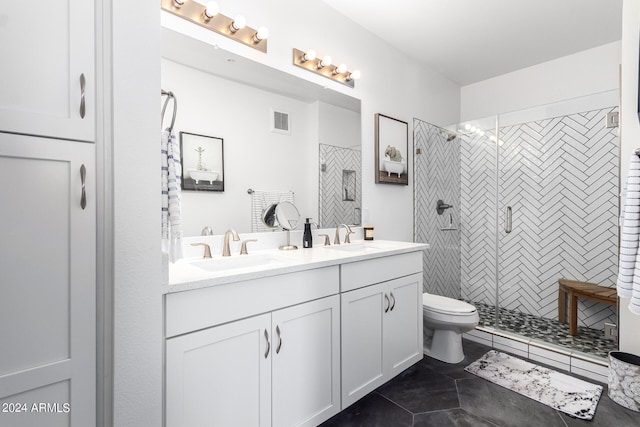 bathroom featuring vanity, toilet, and a tile shower