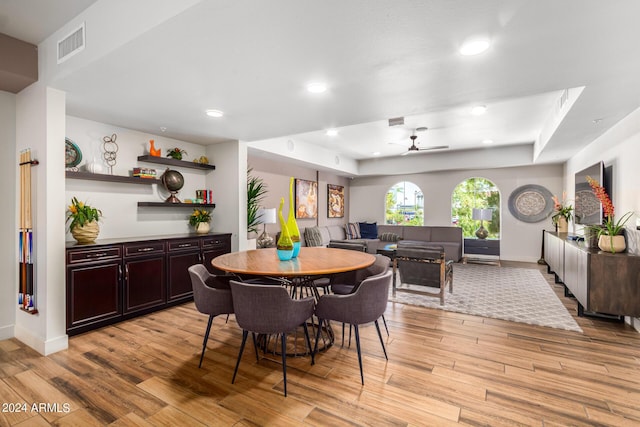 dining area with ceiling fan and light hardwood / wood-style floors