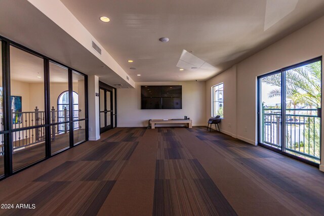 interior space with dark colored carpet