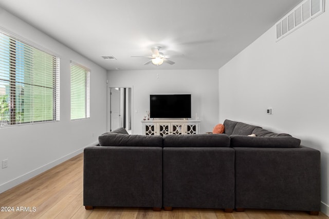 living room featuring ceiling fan and light wood-type flooring