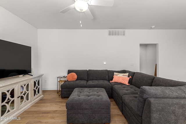 living room with ceiling fan and light wood-type flooring