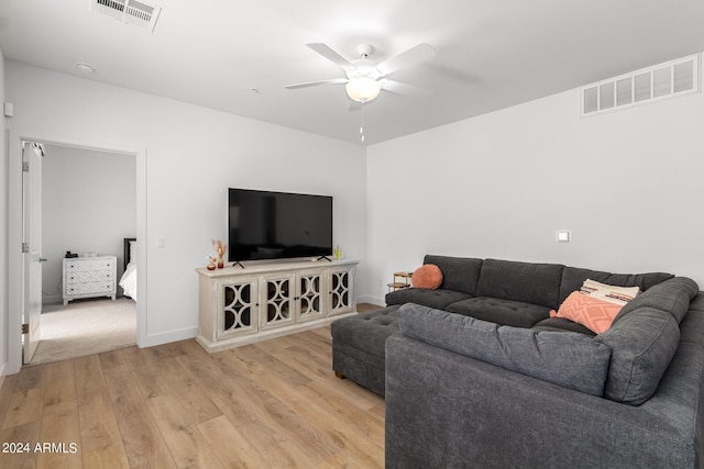 living room with ceiling fan and light hardwood / wood-style floors