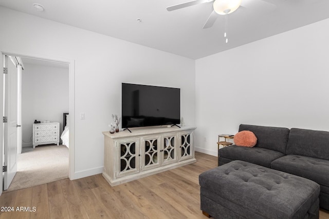 living room featuring light hardwood / wood-style flooring and ceiling fan