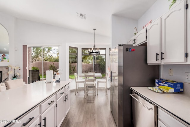 kitchen featuring visible vents, a notable chandelier, plenty of natural light, white cabinetry, and light countertops