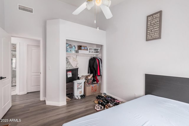 bedroom featuring visible vents, baseboards, a closet, and wood finished floors